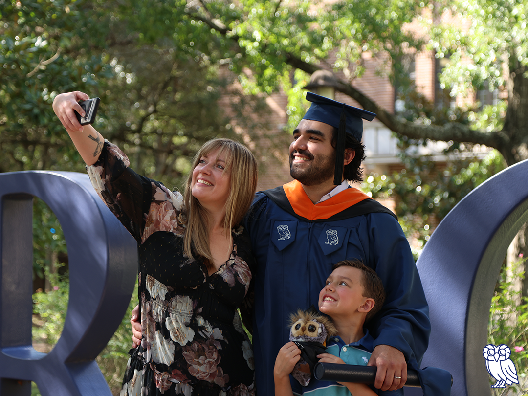 A family selfie featuring a man, a woman, and their son, all smiling and enjoying a fun moment together.