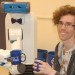 Robot and Zak Kingston holding coffee cups